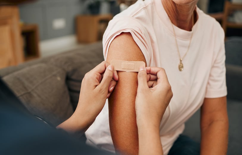 woman receiving bandaid after covid vaccine